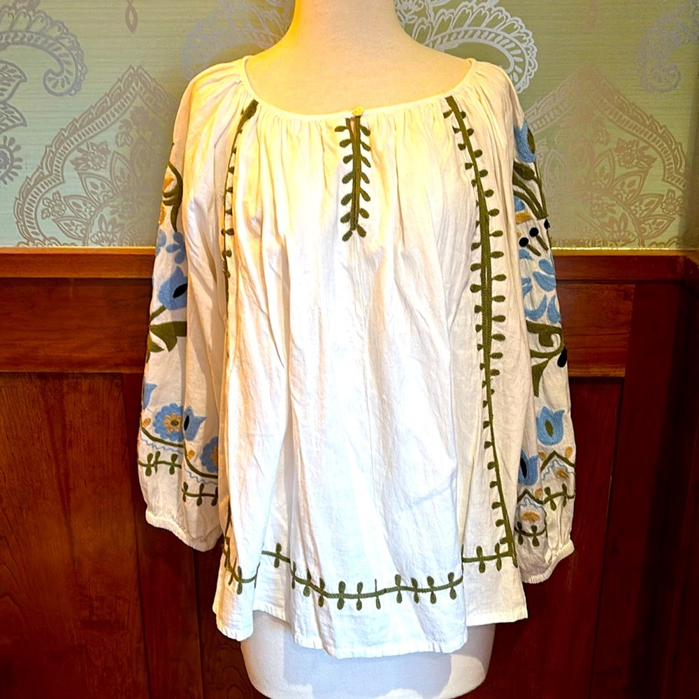 White cotton blouse with beautiful floral embroidery on sleeves